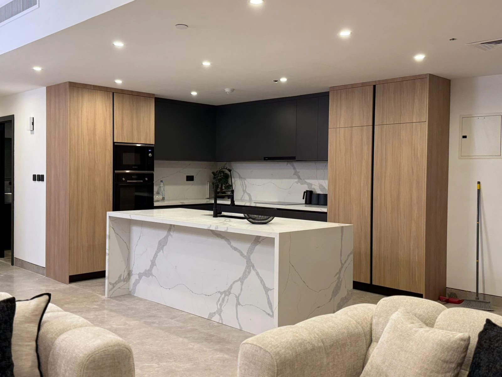 Completed contemporary kitchen with oak cabinetry and stone island